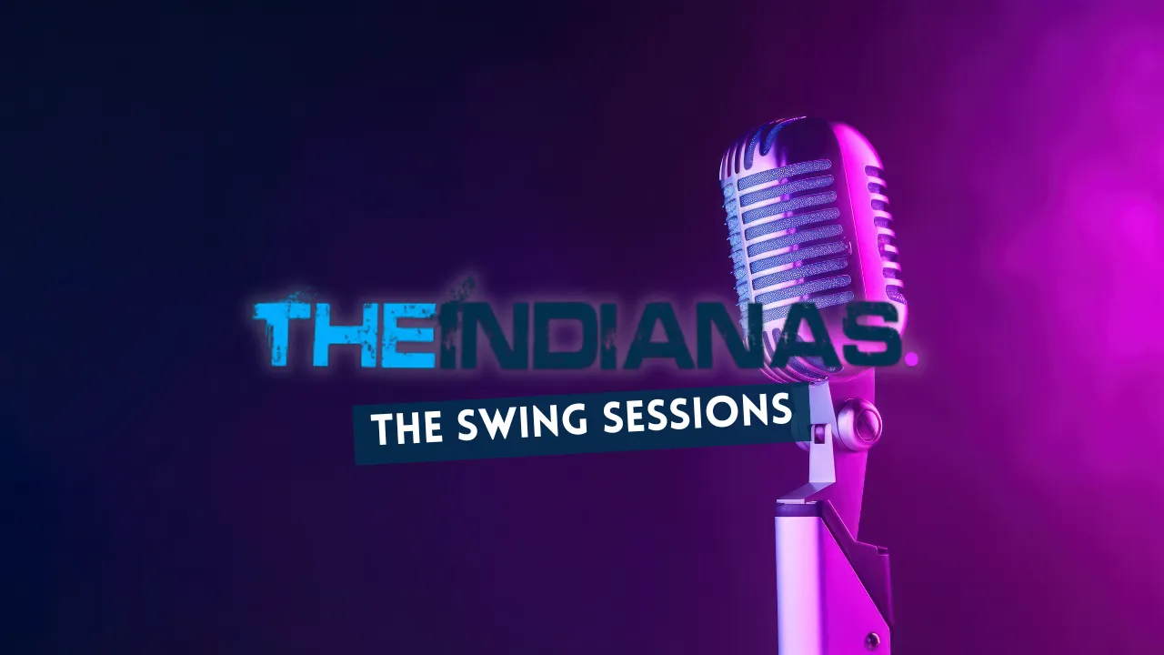 Retro microphone illuminated with purple light next to the blue and black text 'THE INDIANAS. THE SWING SESSIONS' on a dark background.